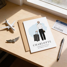 a card with a drawing of a woman in pilot's uniform, a pen, a small airplane, and a passport on a desk.