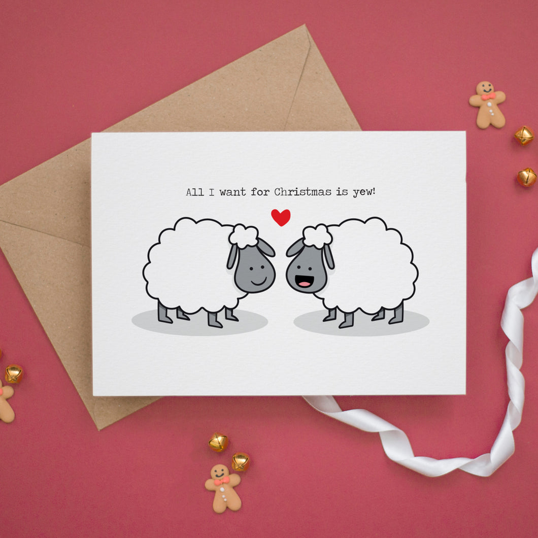 a card with two sheep on it and a teddy bear next to it