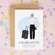A greeting card with an illustration of a woman in pilot's uniform, holding a suitcase, and the name "Charlotte" written below.