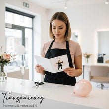 A woman is standing in a salon, holding a card with an illustration of a woman on it, and appears to be reading or looking at the card.