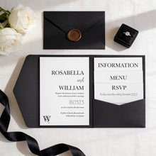 a black wedding invitation card with white text and a black envelope, along with a ring box and a rose arrangement.