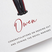 a card with a red text that reads "Owen" and "CONGRATULATIONS ON PASSING OUT AND JOINING THE ROYAL MARINES".