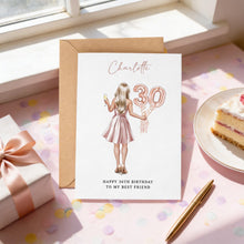 A birthday card for " Charlotte 30th Birthday to my best friend" is displayed on a pink table with a slice of cake, a gift box, and a pen.