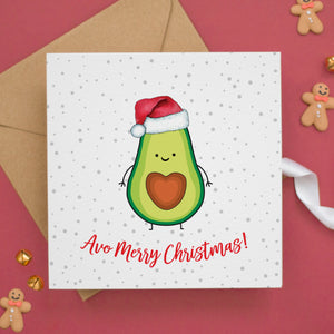 a christmas card with an avocado wearing a santa hat