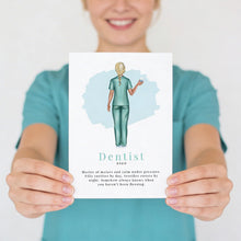 a woman wearing a teal shirt and holding a card with an illustration of a woman in a dental uniform.