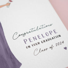 The image is a close-up of a graduation card with a purple background and white text.