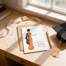 a graduation card with a female illustration, a graduation cap, and confetti on a desk.
