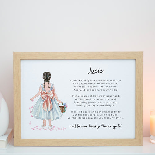 The image is a framed print featuring a hand-drawn illustration of a young girl in a blue dress with a pink bow, holding a basket of flowers. The text is a poem about a girl named Lucie, and the image is framed in a wooden frame.