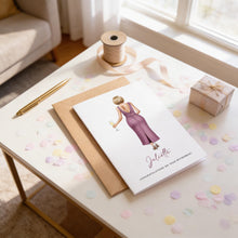 a card with a woman in a purple dress, a gift box, and confetti on a table.