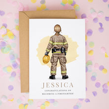 A card with an illustration of a firefighter and the name "JESSICA" printed on it, along with the text "CONGRATULATIONS ON BECOMING A FIREFIGHTER!" The card is placed on a background of confetti.