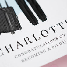 a close-up of a graphic design with a suitcase and a pair of pants, along with the text "Charlottie" and "Congratulations on becoming a pilot!"