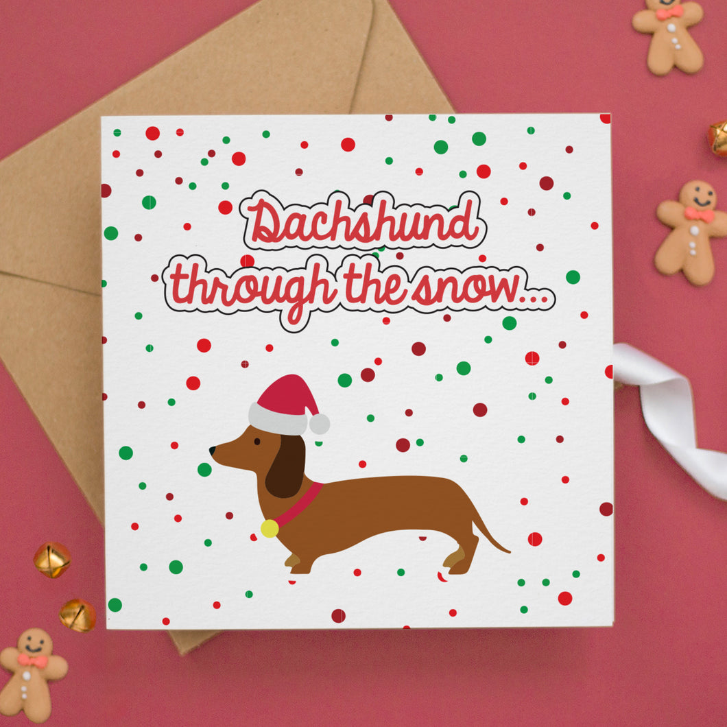 a card with a dachshund through the snow on it