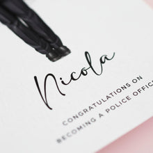 a close-up of a card with a name and a congratulatory message.