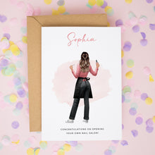a greeting card with a woman's back facing the viewer, wearing a pink shirt and black pants, holding a phone. The card is set against a background of confetti in various colors.