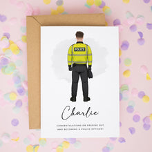 A greeting card featuring an illustration of a police officer in a yellow uniform, with the name "Charlie" written below.