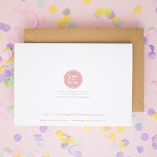 a white card with text and a pink logo, surrounded by colorful confetti on a pink background.
