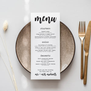 a menu sitting on top of a plate next to a fork and knife