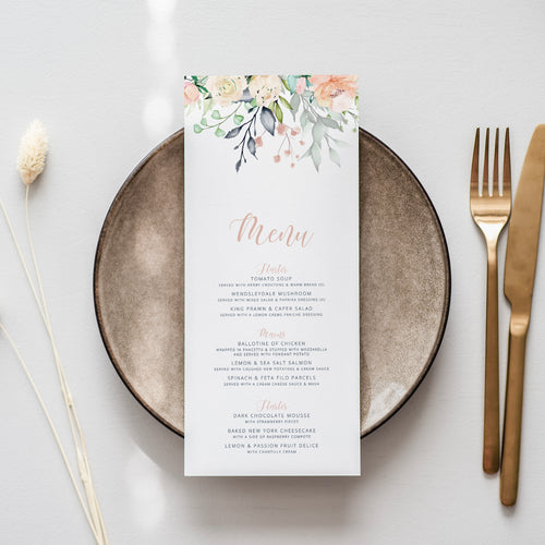 a table setting with a menu and gold cutlery